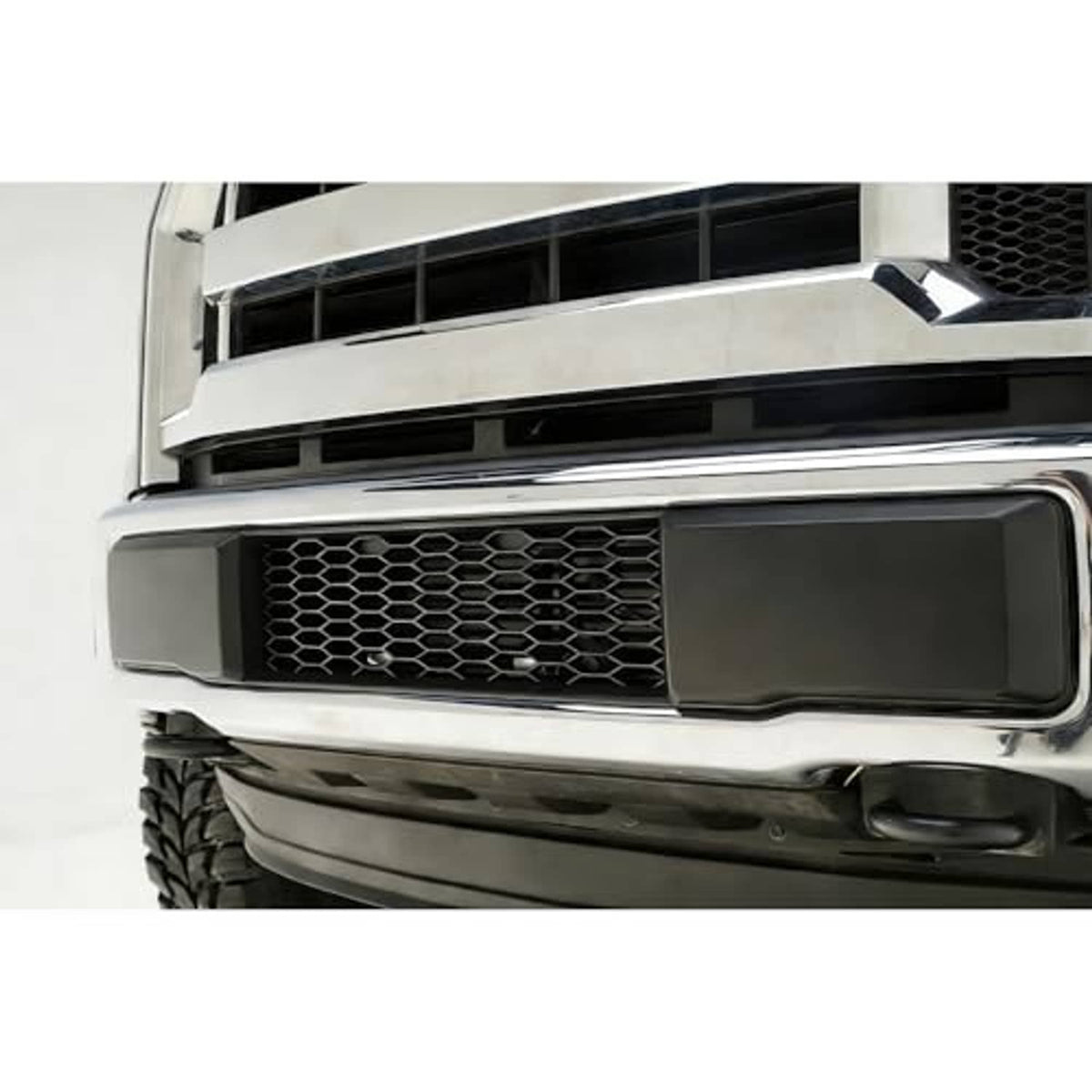 Front bumper grille opening with black surround and honeycomb mesh insert