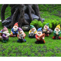 Miniature resin gnome figurines set of 7, colorful hats, posed on grass