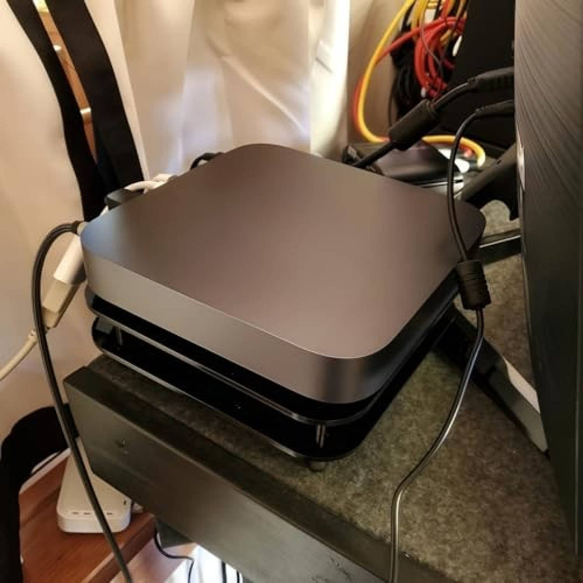 Mac mini radiator cooling fan with cables connected, matte top and black double-deck base