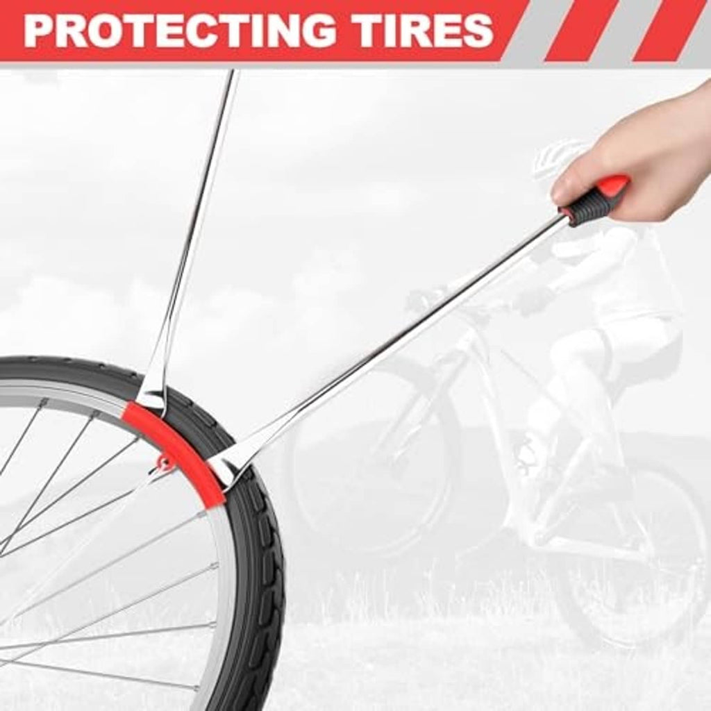 Tire spoon tool reaching under a motorcycle tire edge for careful prying