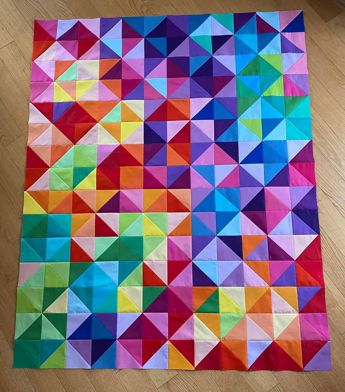 Multicolor patchwork fabric squares arranged in a quilt-style square layout