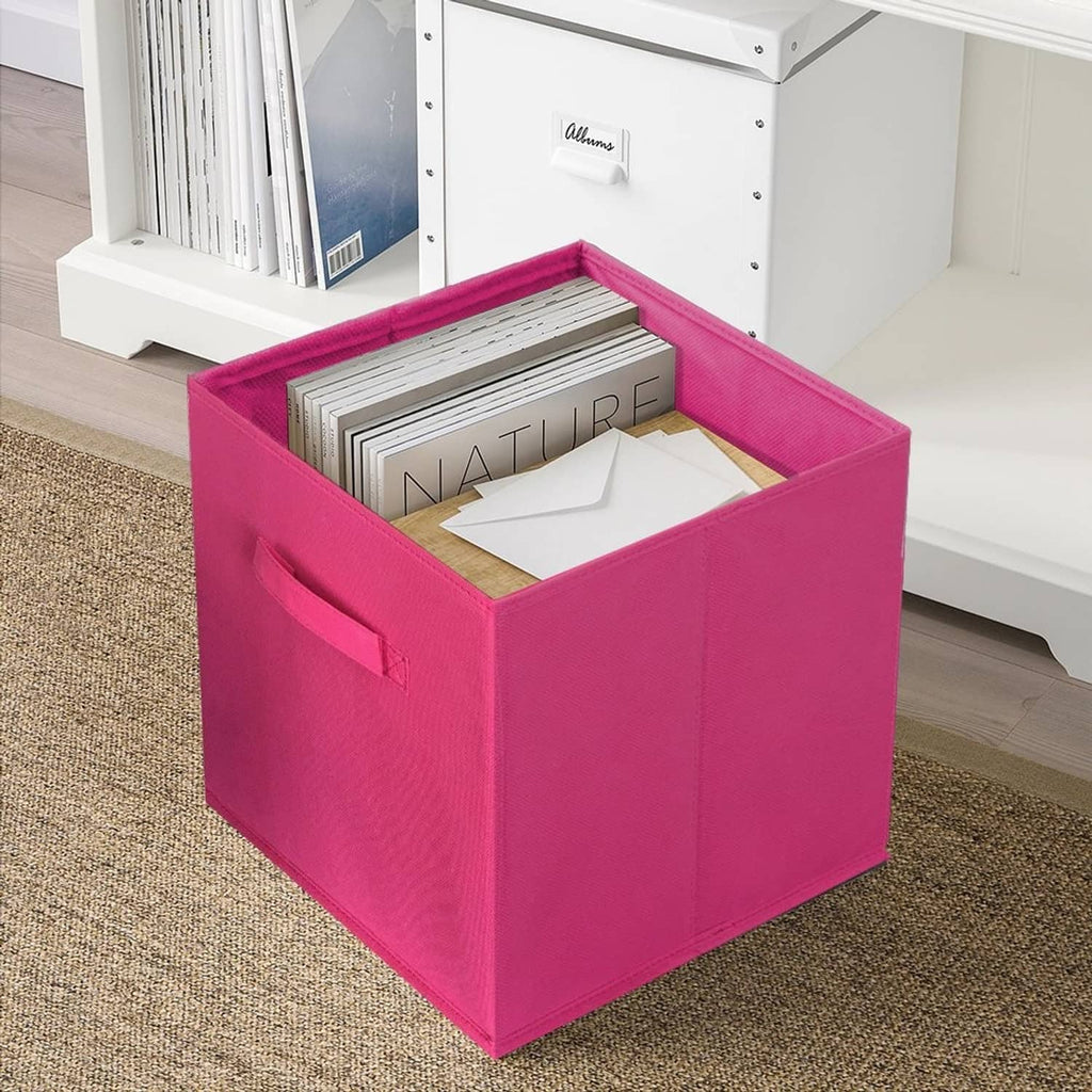 Fuchsia foldable fabric storage cube with open top holding folded papers