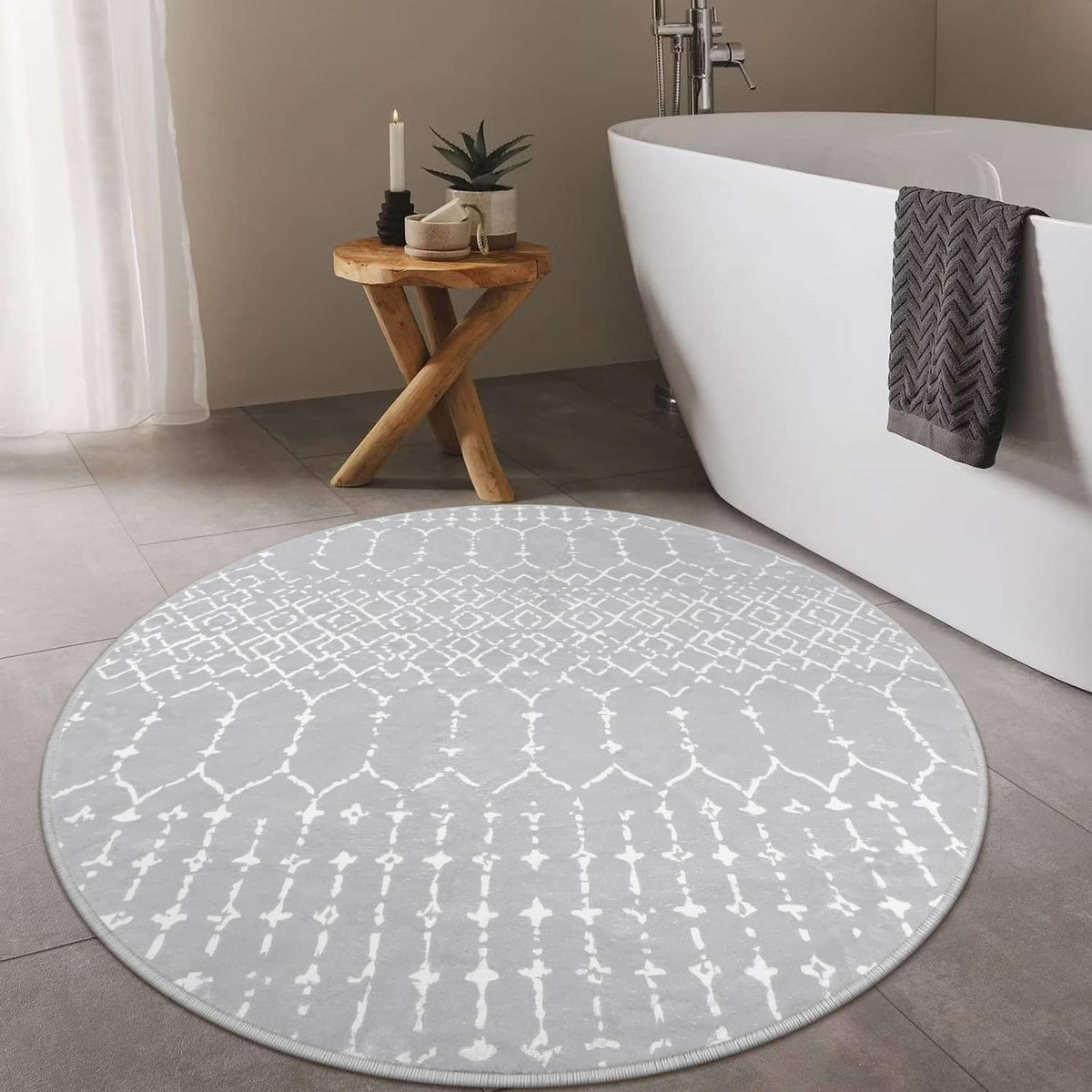 Grey round rug with white Moroccan pattern, circular edge and soft low-pile texture