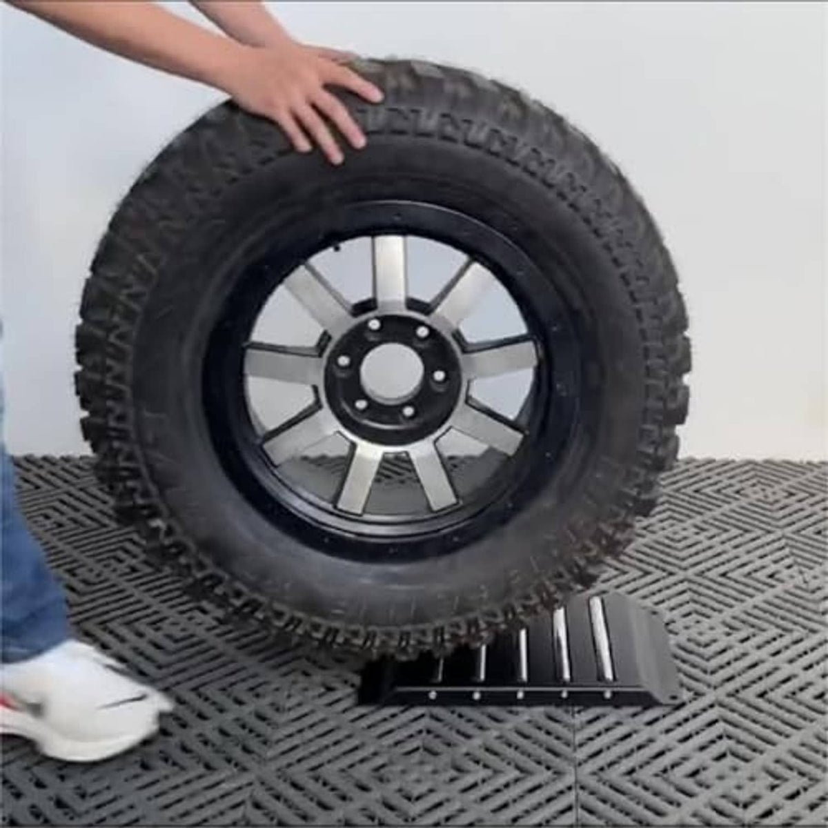 Tire on black slatted base platform for tire changer