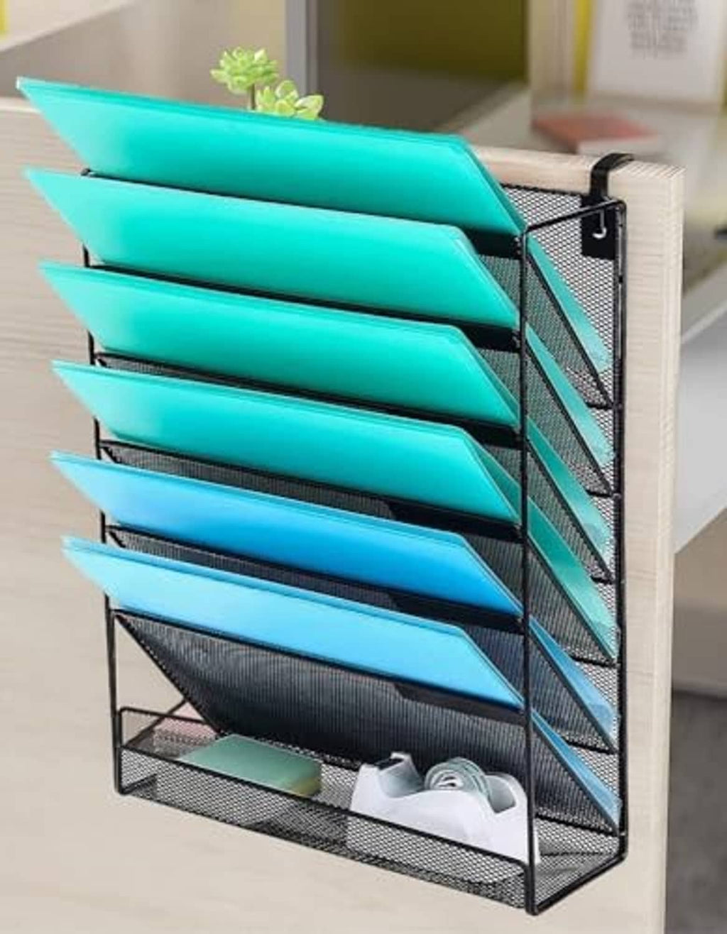 Wall-mounted document organizer with black mesh frame and teal letter-size trays