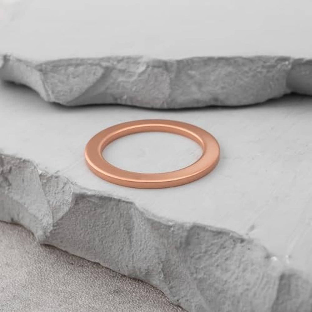 Brown round gasket washer ring placed on rough gray surface