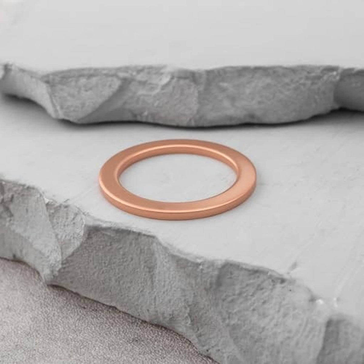 Brown round gasket washer ring placed on rough gray surface