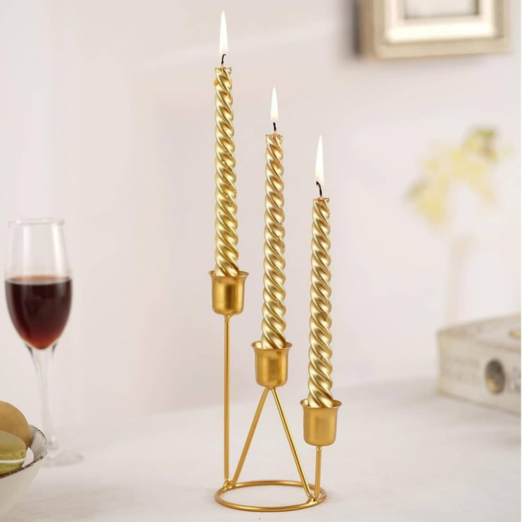 Gold three-cup candle holder with twisted candlesticks on a round stand