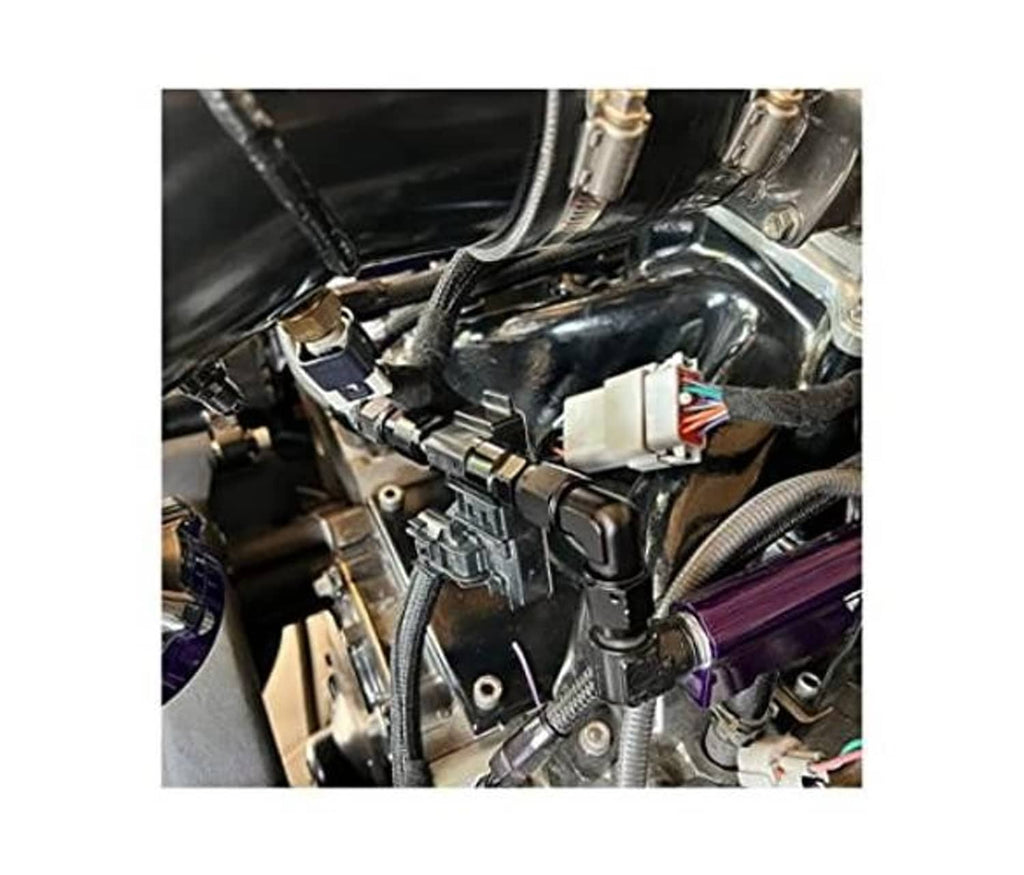Black 90-degree AN flare fitting adapters installed in an engine compartment