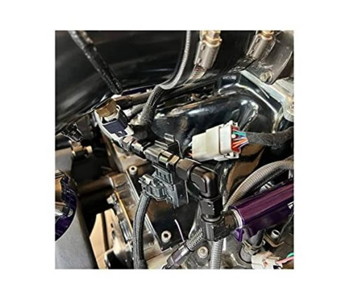 Black 90-degree AN flare fitting adapters installed in an engine compartment