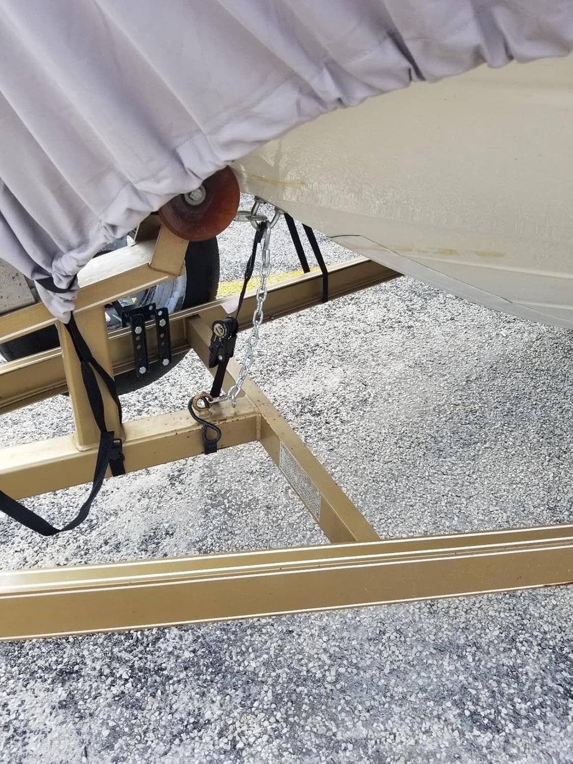 Bow safety chain hanging from trailer attachment under boat