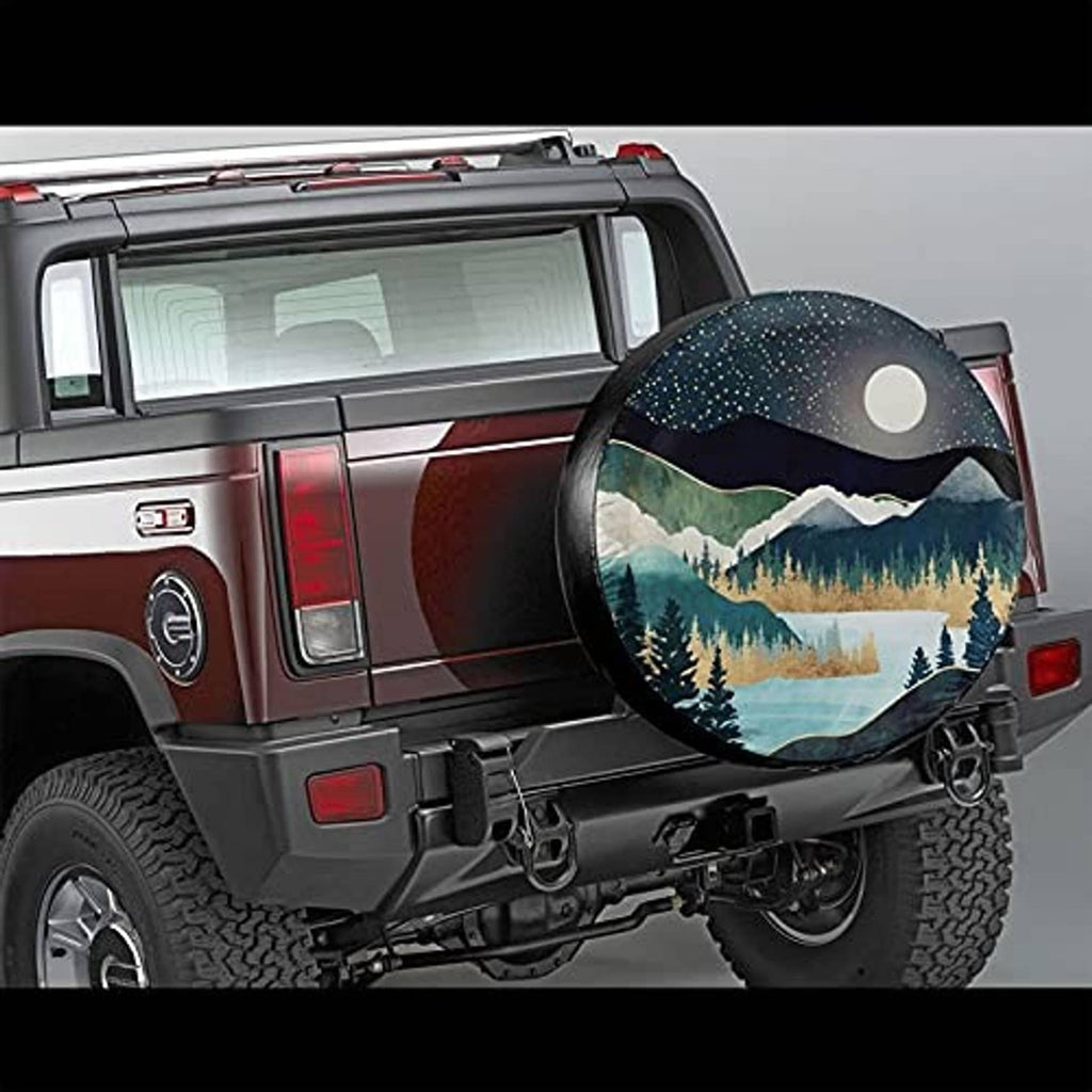 Tire cover on spare wheel with starry night mountains and pine forest under a moon
