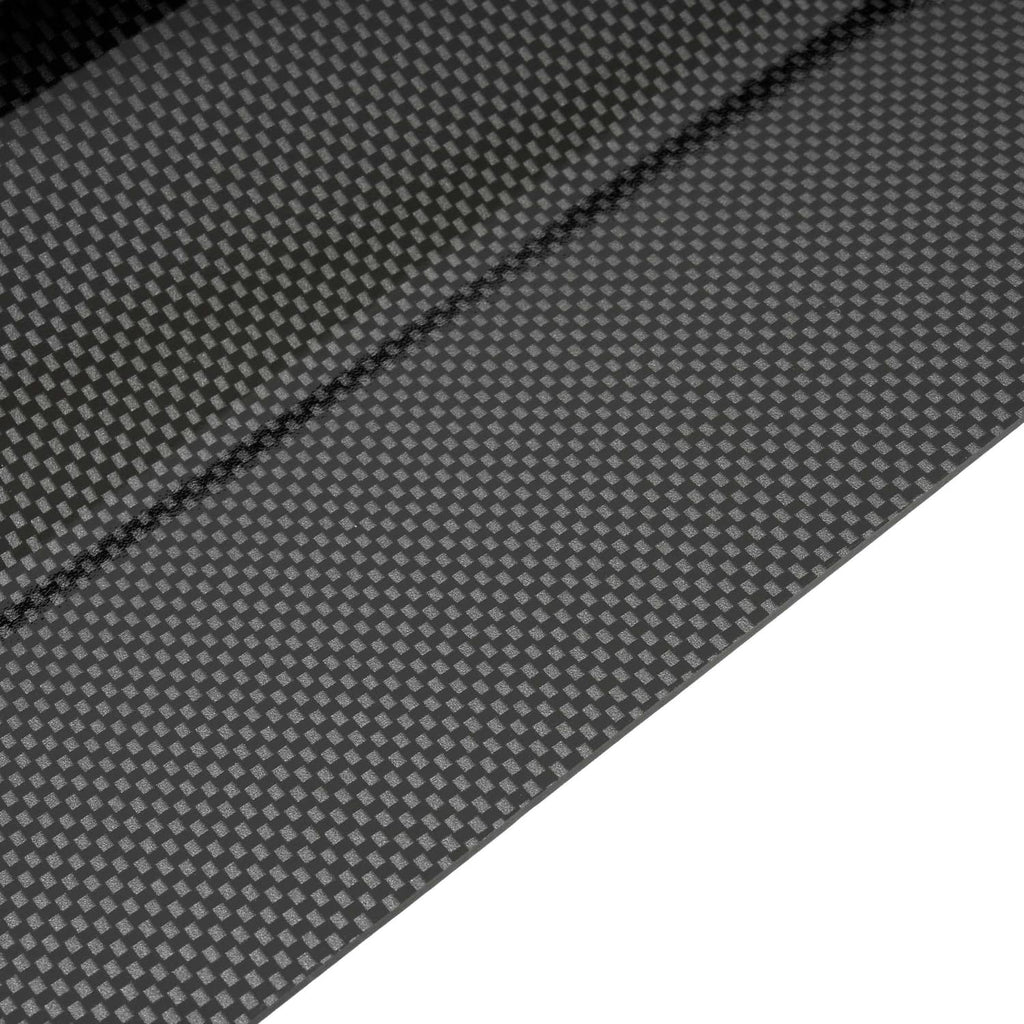 Carbon fiber style dash board cover texture close-up on dark gray surface