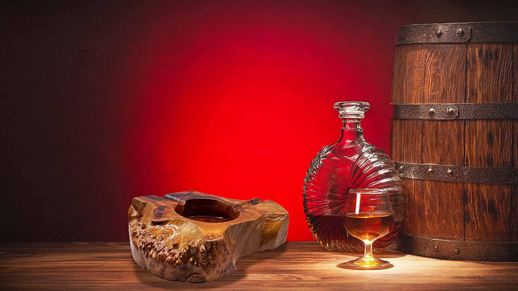 Wooden cigar ashtray on tabletop with carved bowl opening and cigar rest groove