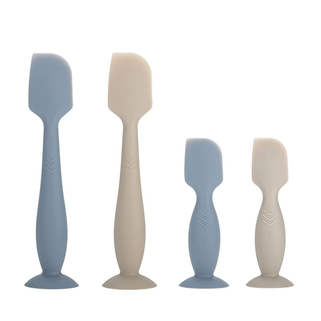Set of four silicone diaper cream spatula applicators in dark blue and beige