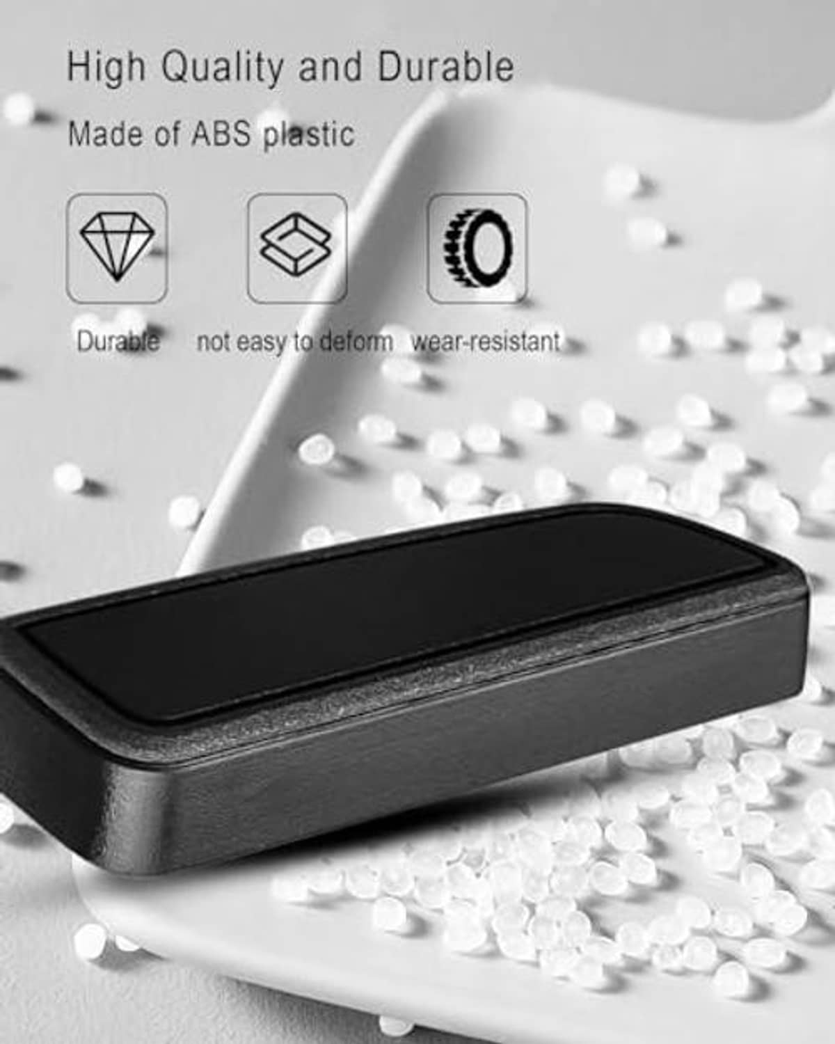 Black ABS seat adjustment button trim with raised textured outer edge.