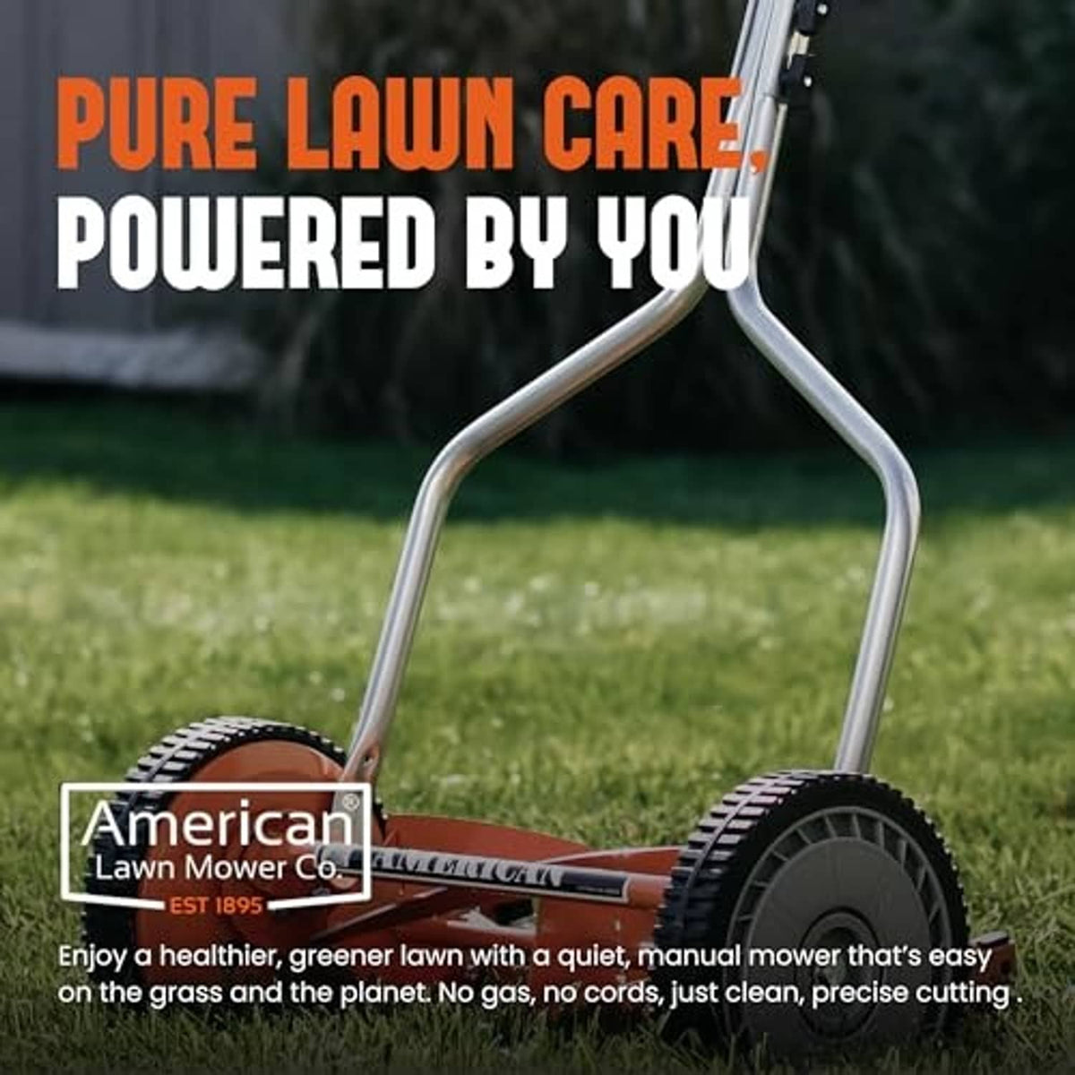 Manual reel lawn mower with silver handle and orange-red cutting deck