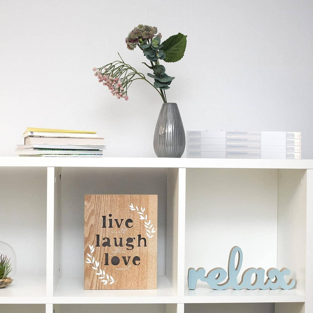 Clear A4 document protectors displayed on a shelf with notebooks and decor