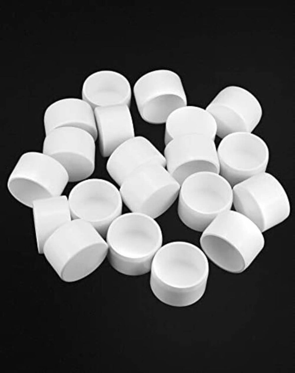 White 1-1/4 in PVC pipe end caps, assorted caps piled together