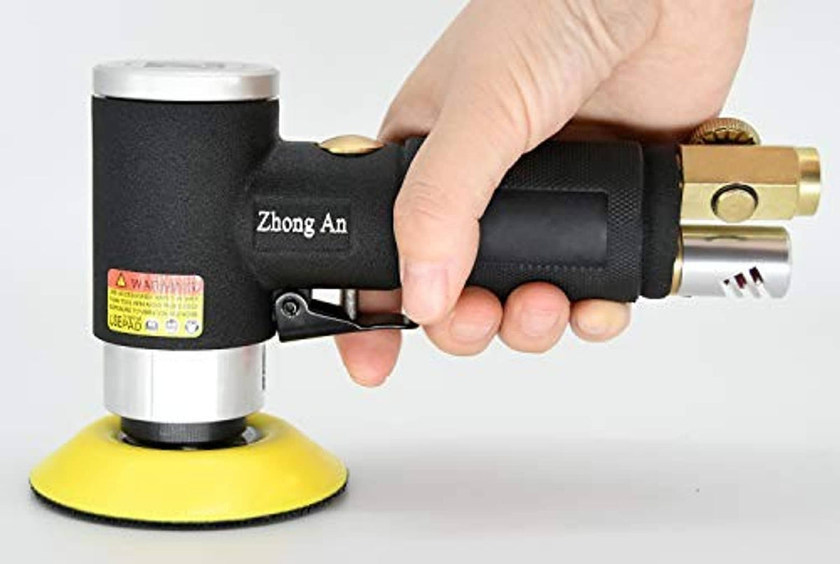Air dual-action orbital sander with black grip and yellow sanding pad held by hand