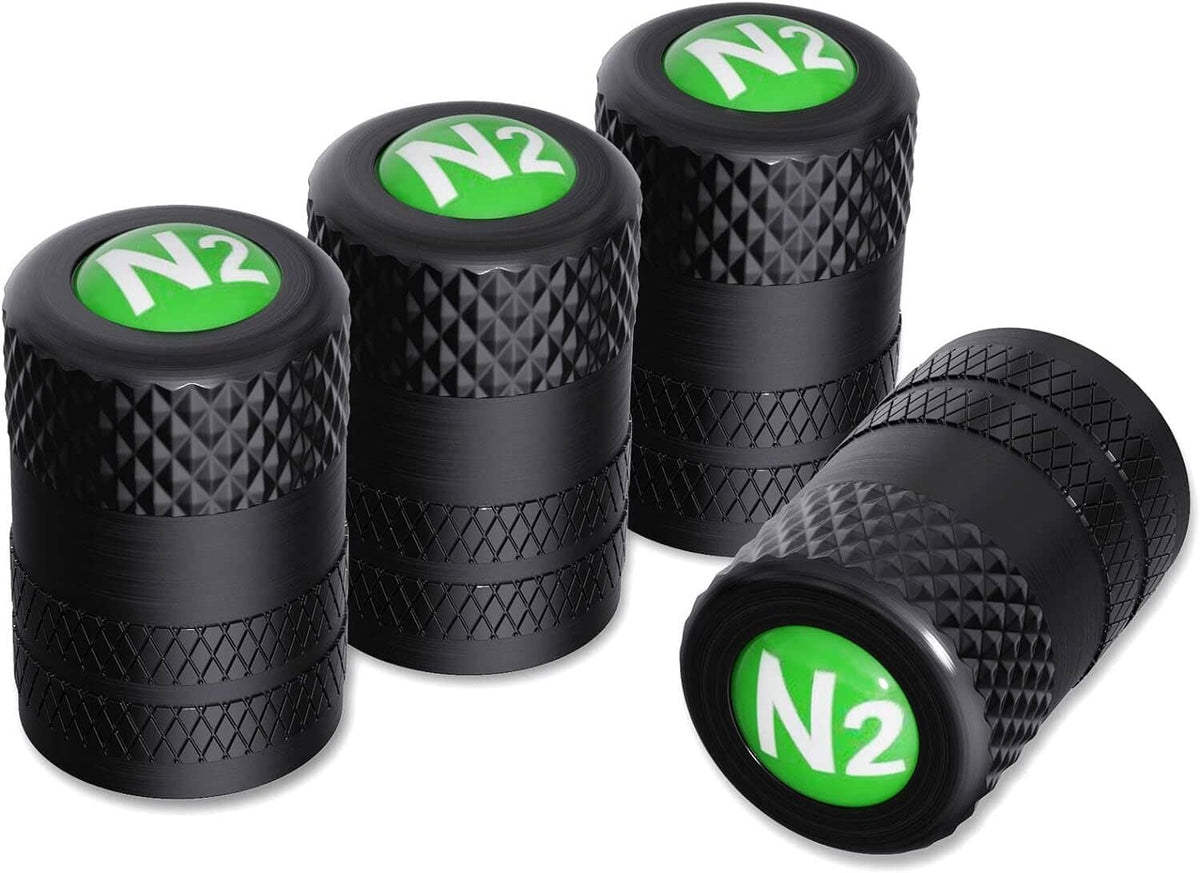 Five black tire valve stem caps with green N2 logo and textured pattern