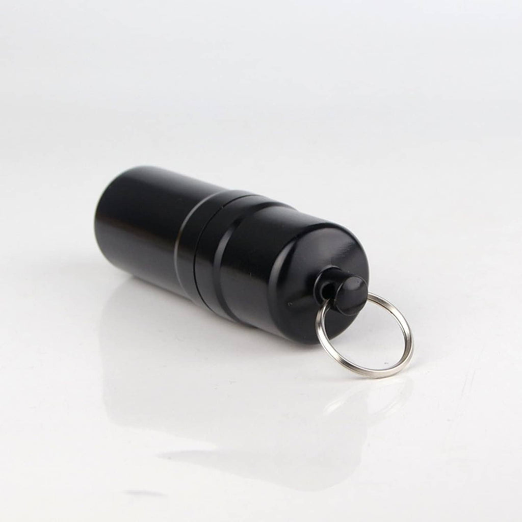 Side view of black round cigarette case with attached metal key ring