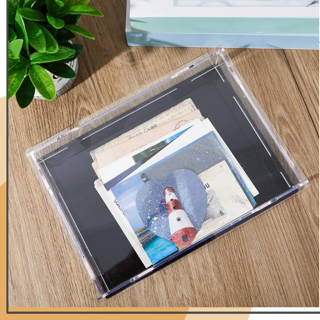 Clear acrylic book display case with black base holding books and papers