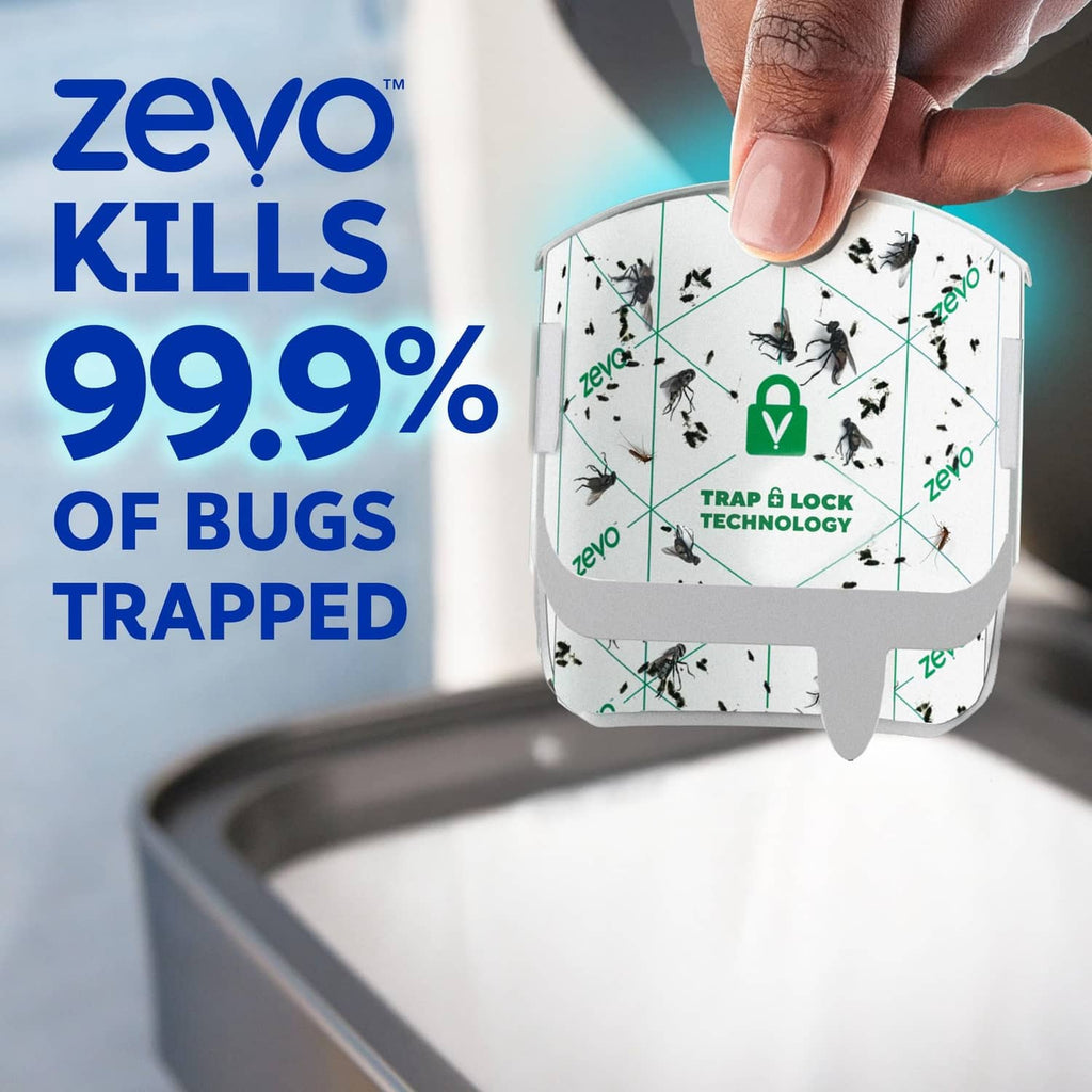Hand holding Zevo compact trap refill cartridge with trapped insect graphic