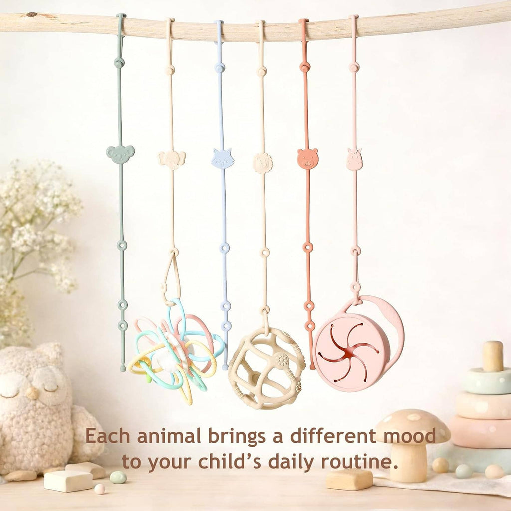 Six hanging silicone baby toy straps with assorted animal and face charms in pastel colors