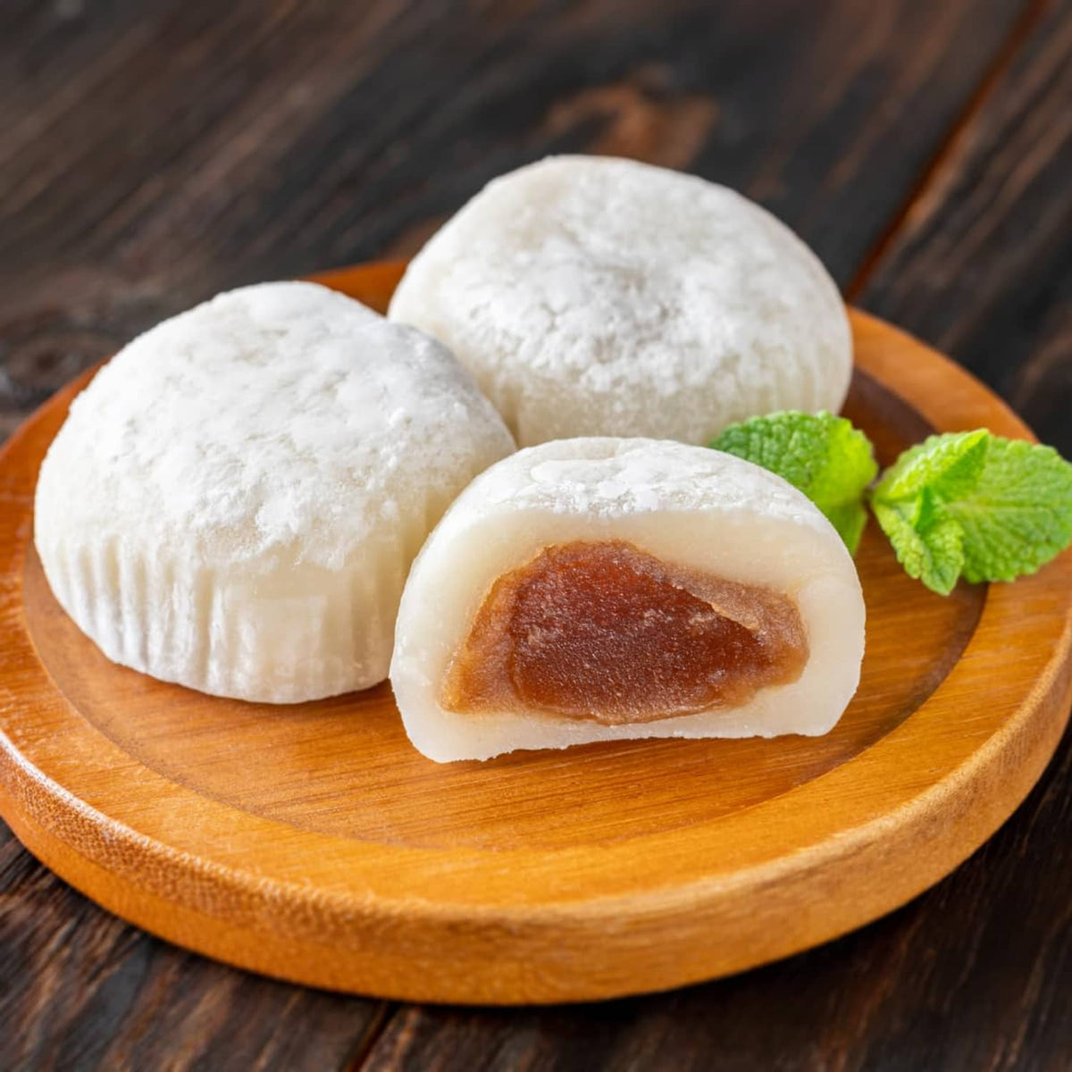 Plate of white mochi rice cakes with caramel-filled center