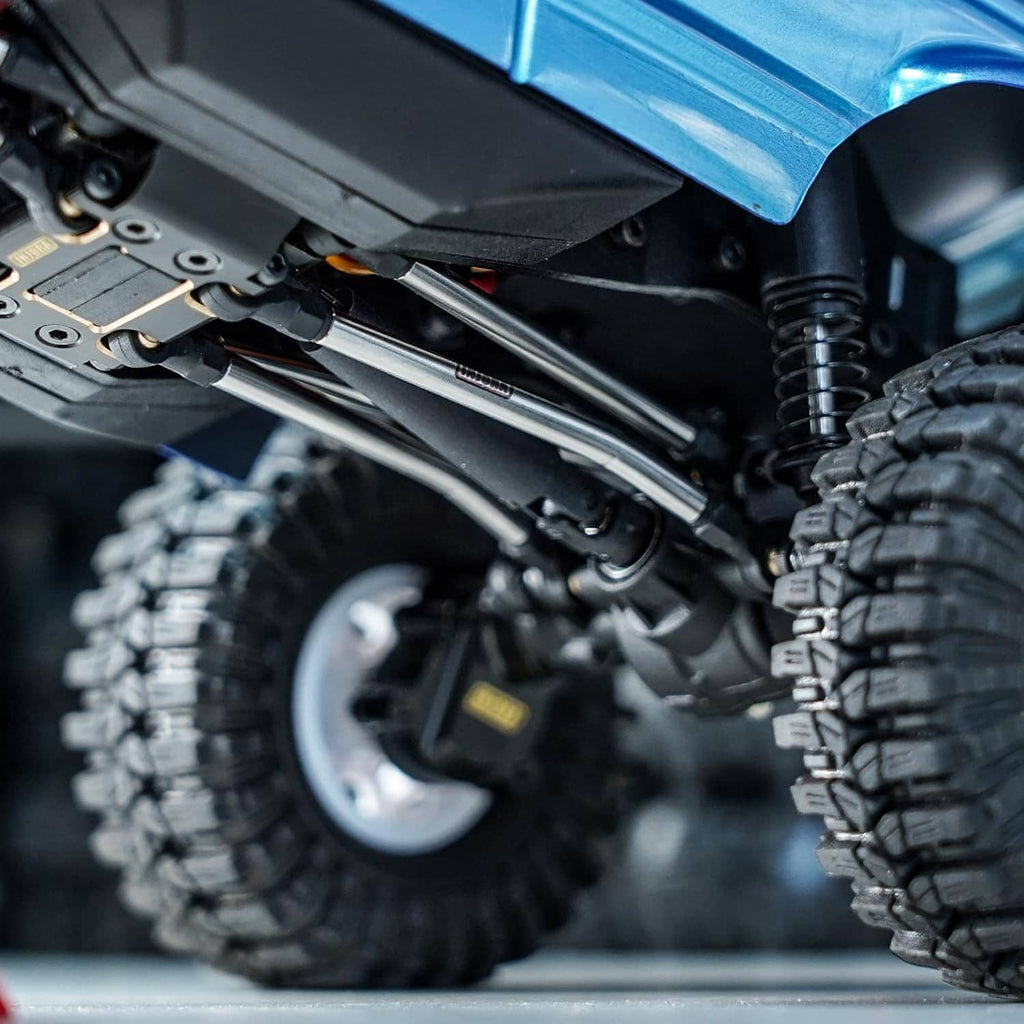 Installed stainless steering links under RC truck chassis with black rubber boots