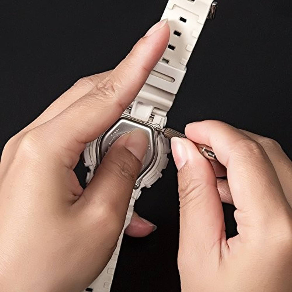 Hands installing a tiny screw on eyeglasses frame for repair and adjustment