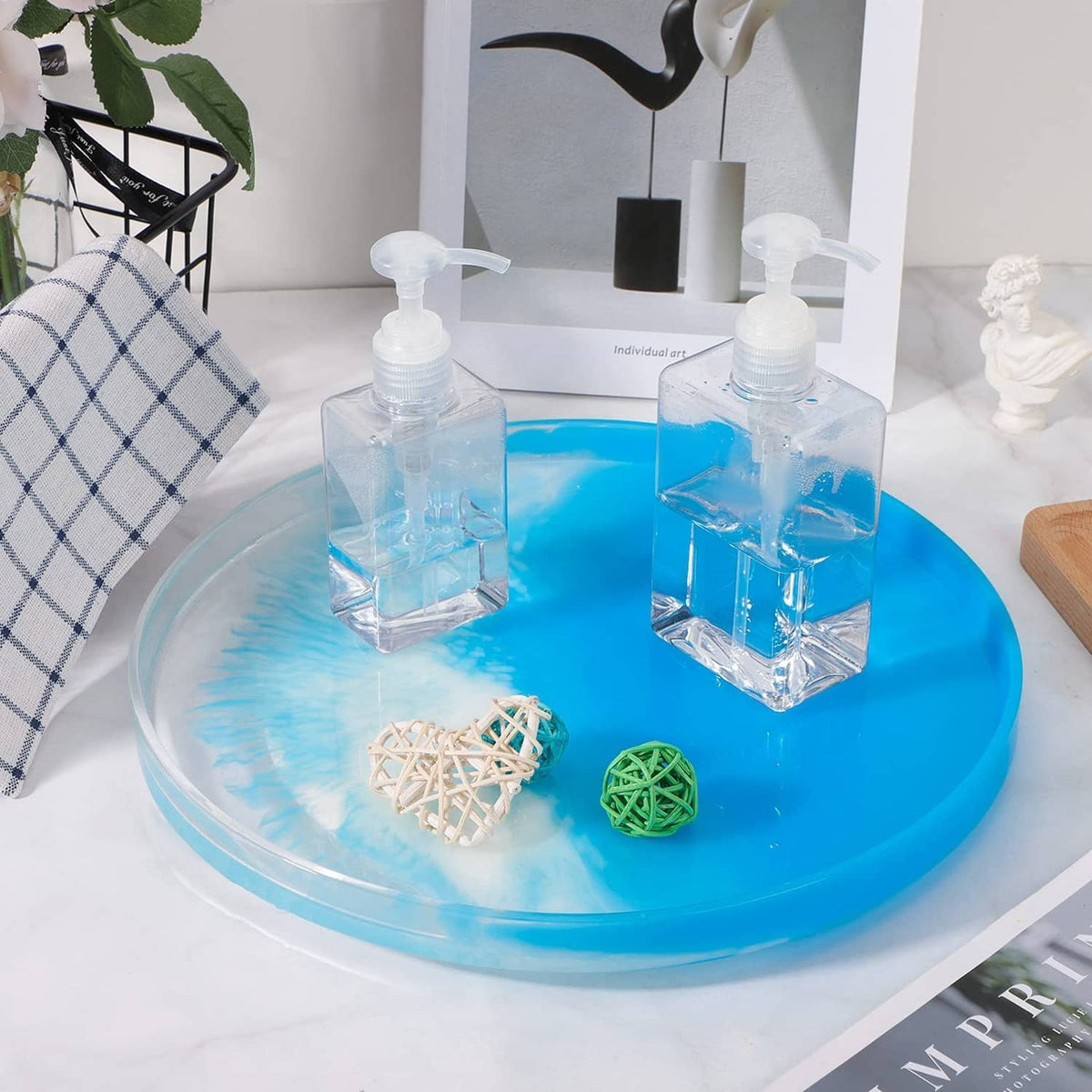 Large round resin serving tray mold filled with blue pour, with mold bottles