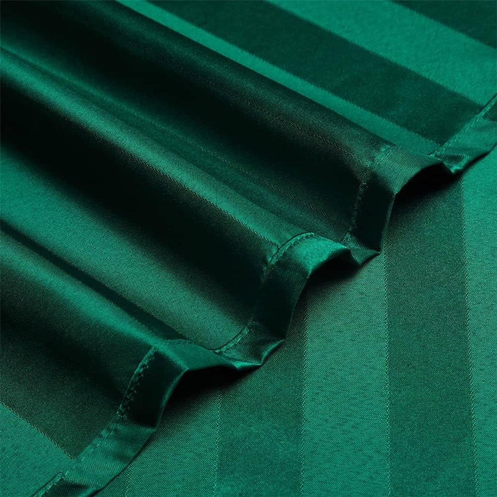 Close-up of teal green satin stripe fabric with neat stitched edge detail