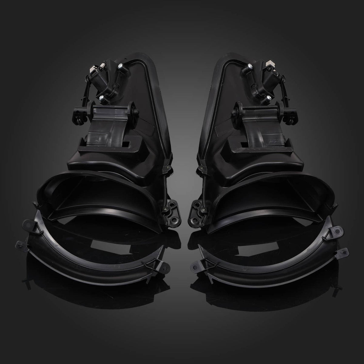 Two black fairing air duct units with circular openings and attached mounting hardware