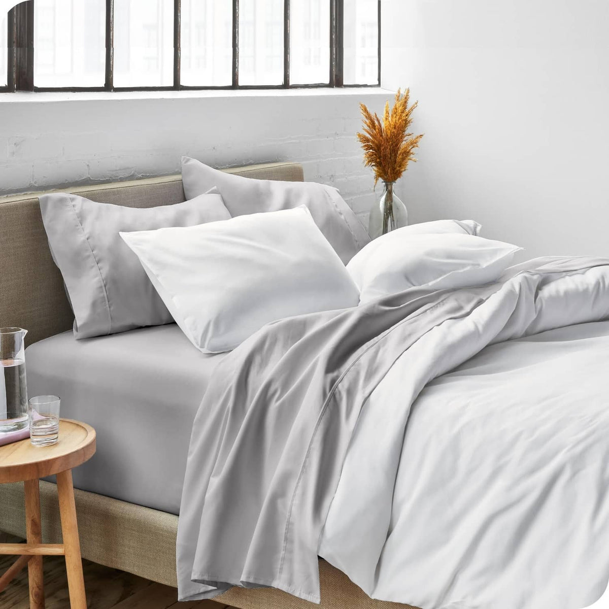 Light grey king sheet set with two pillowcases and neatly draped top sheet