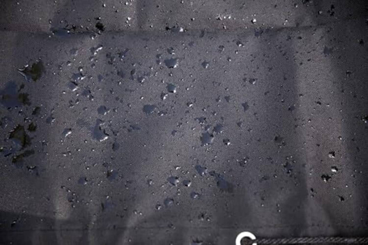 Water-repellent log splitter cover fabric, dark surface with raindrop speckles