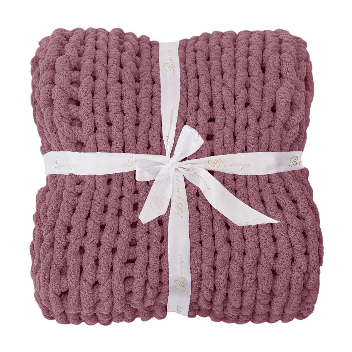 Folded chunky knit throw blanket, burnt rose, tied with white ribbon