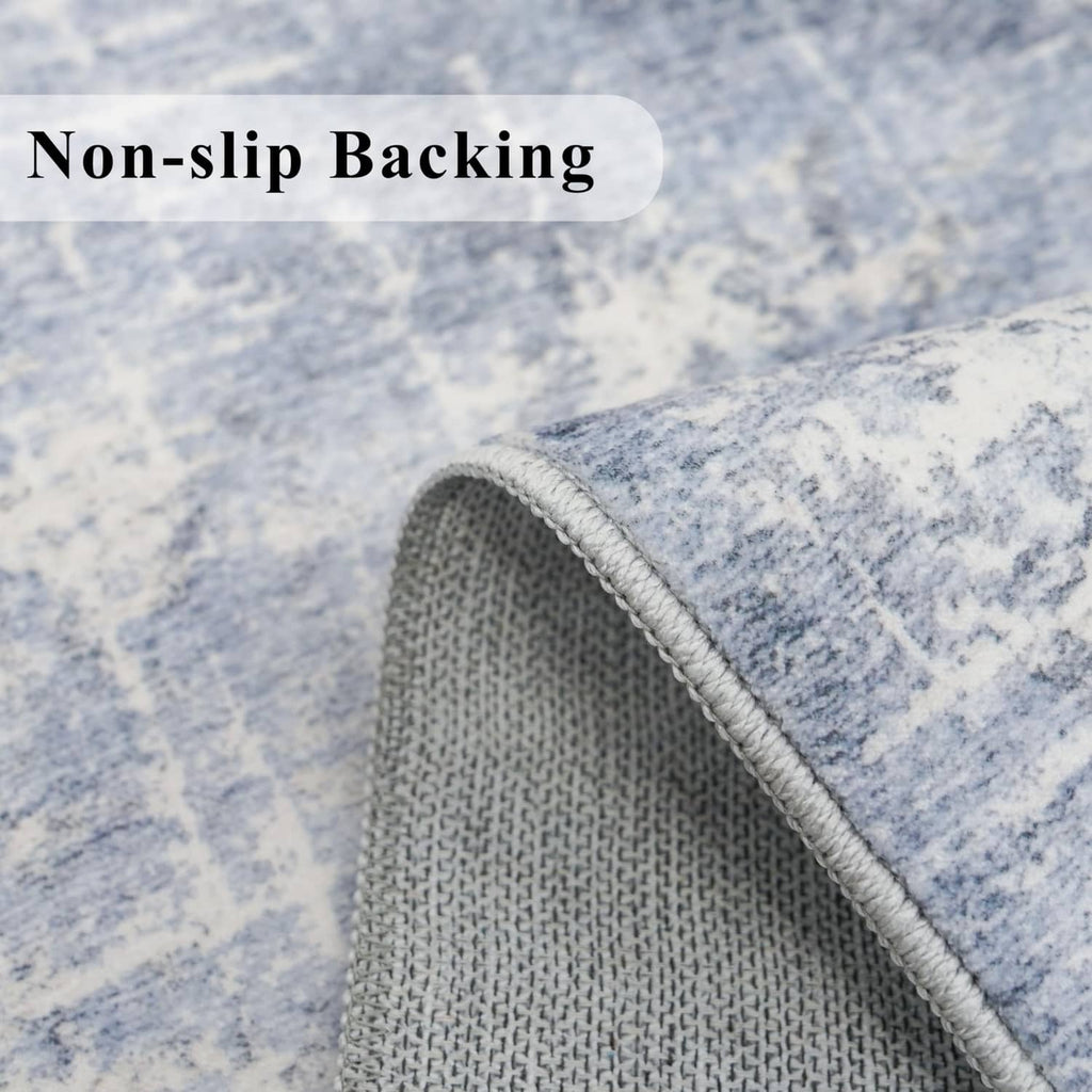 Non-slip backing rug corner in blue and ivory textured fabric with gray edge.