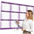 Purple 2027 wall calendar planner with monthly grid and marker writing area