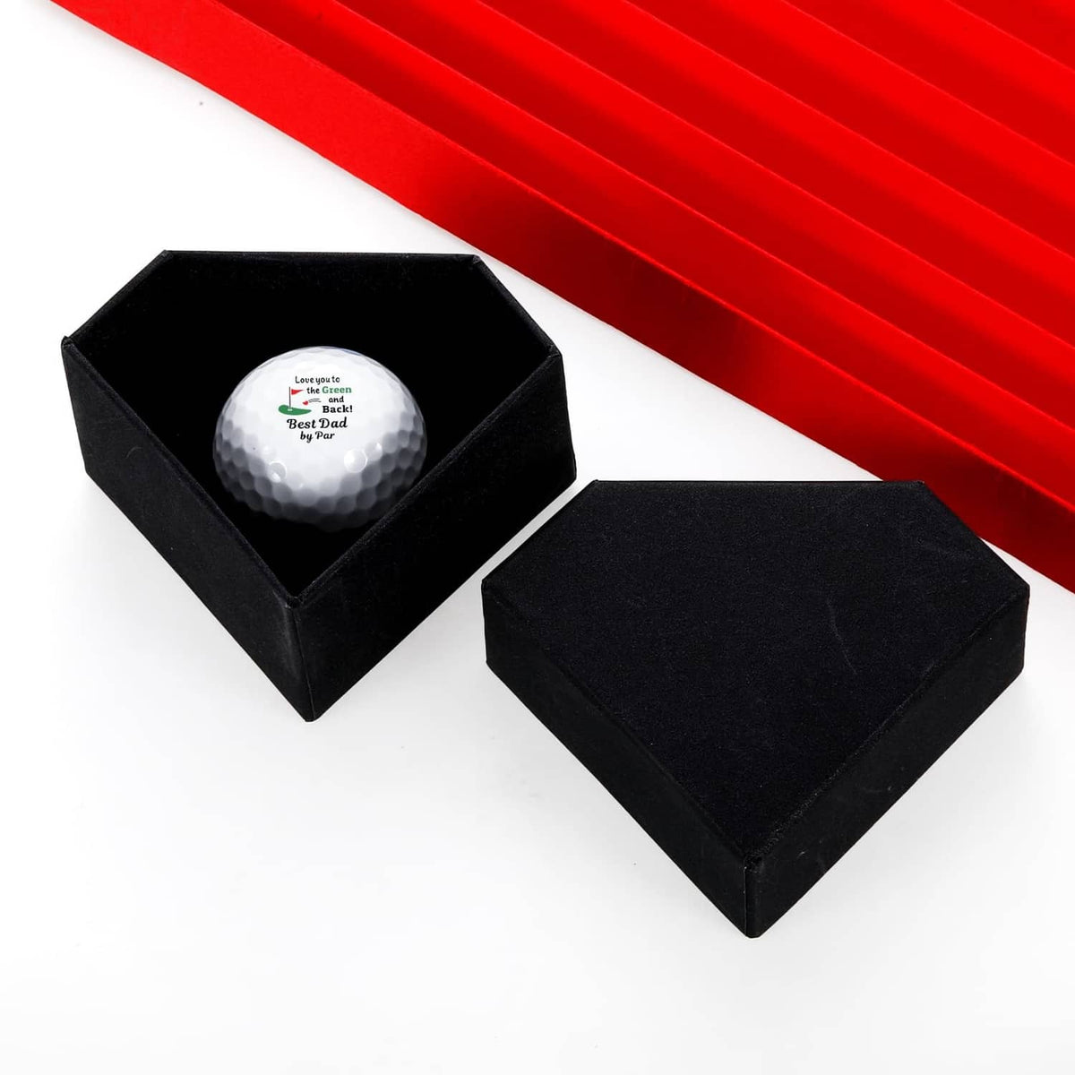 White golf ball in a black gift box