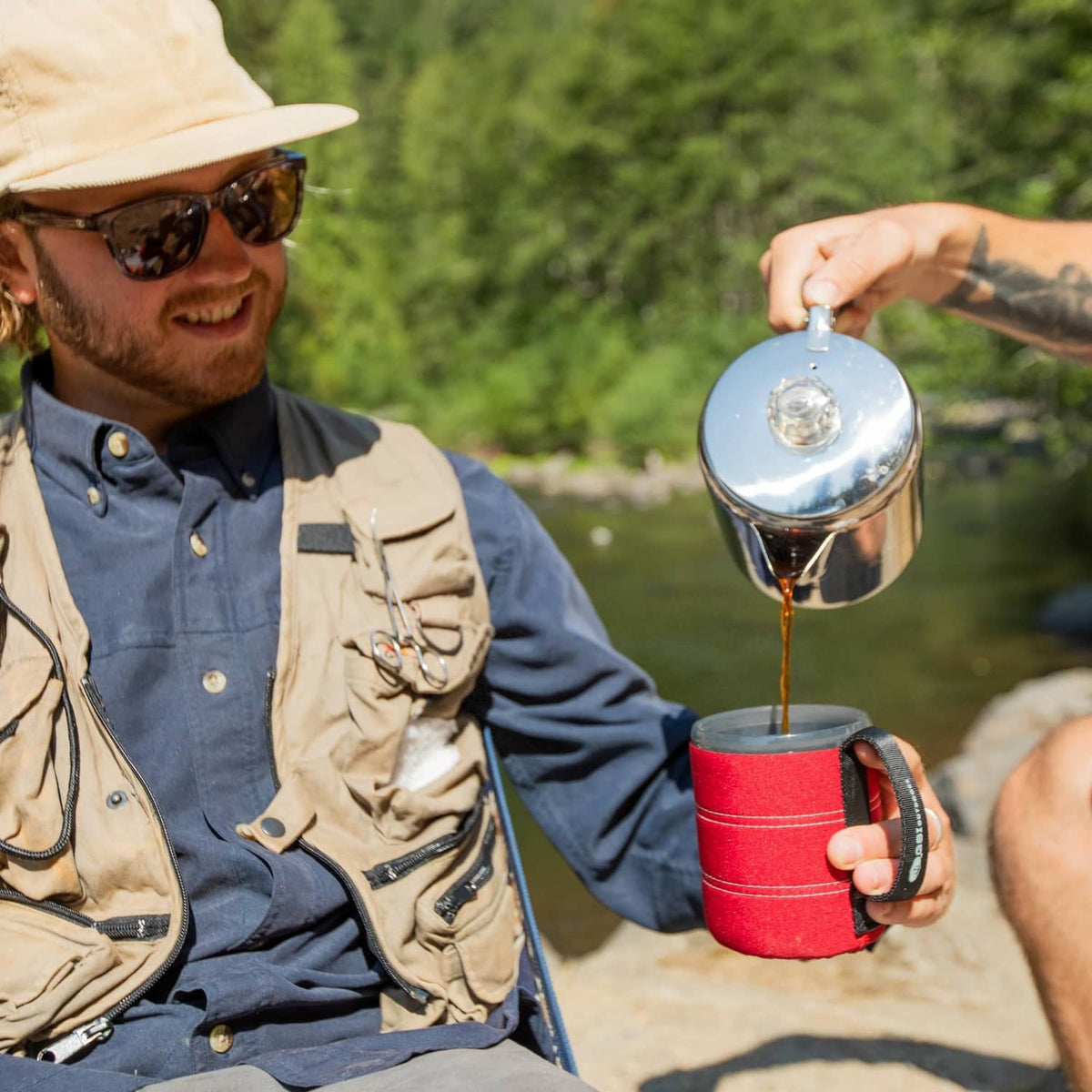 Stainless steel 3-cup coffee percolator pot, pouring coffee into a cup
