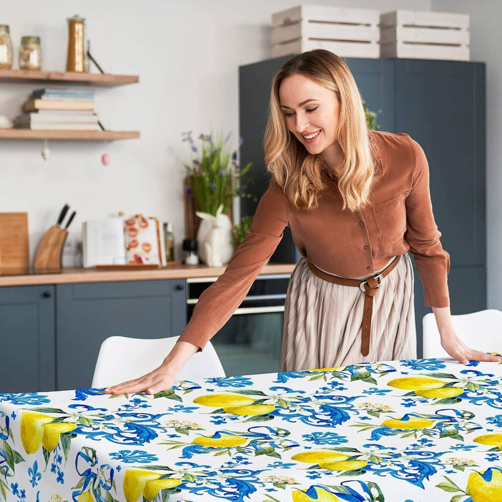 White tablecloth with blue floral and yellow lemon print spread across dining table