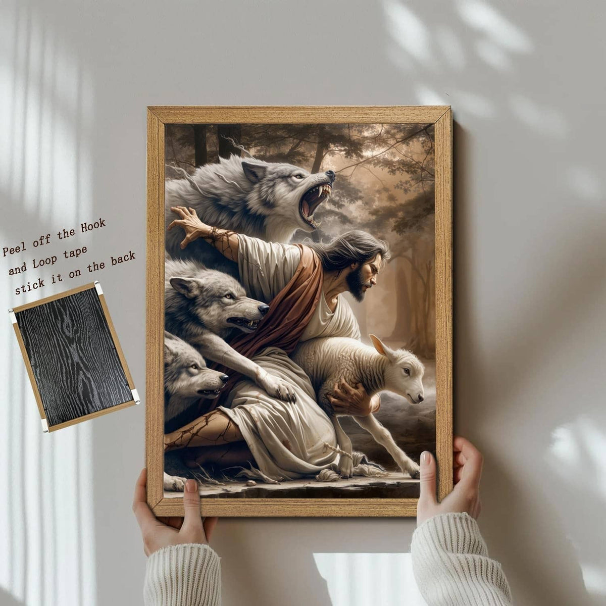 Framed Jesus and lamb canvas wall art, hands holding the wooden frame for hanging
