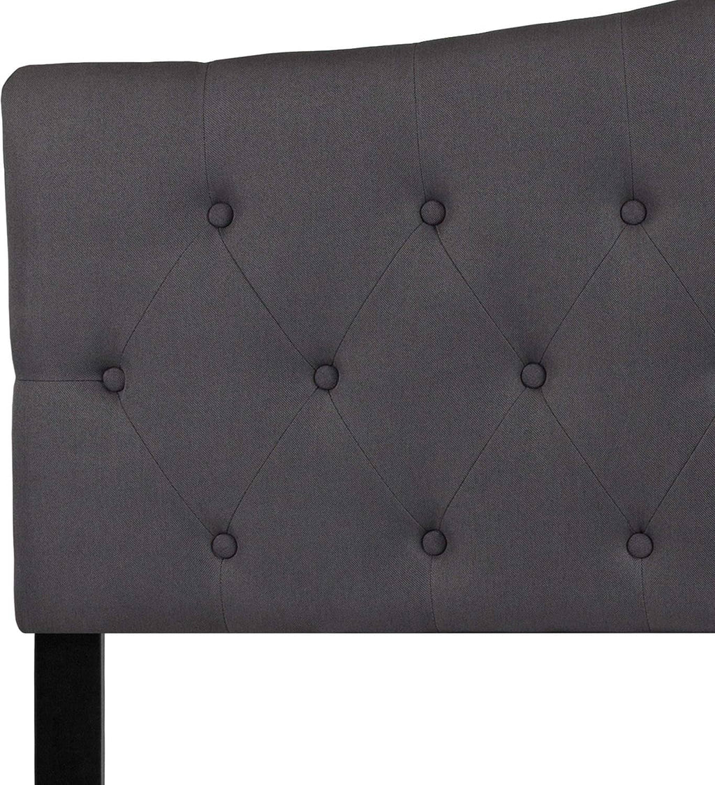 Dark gray tufted fabric headboard panel with buttoned diamond pattern