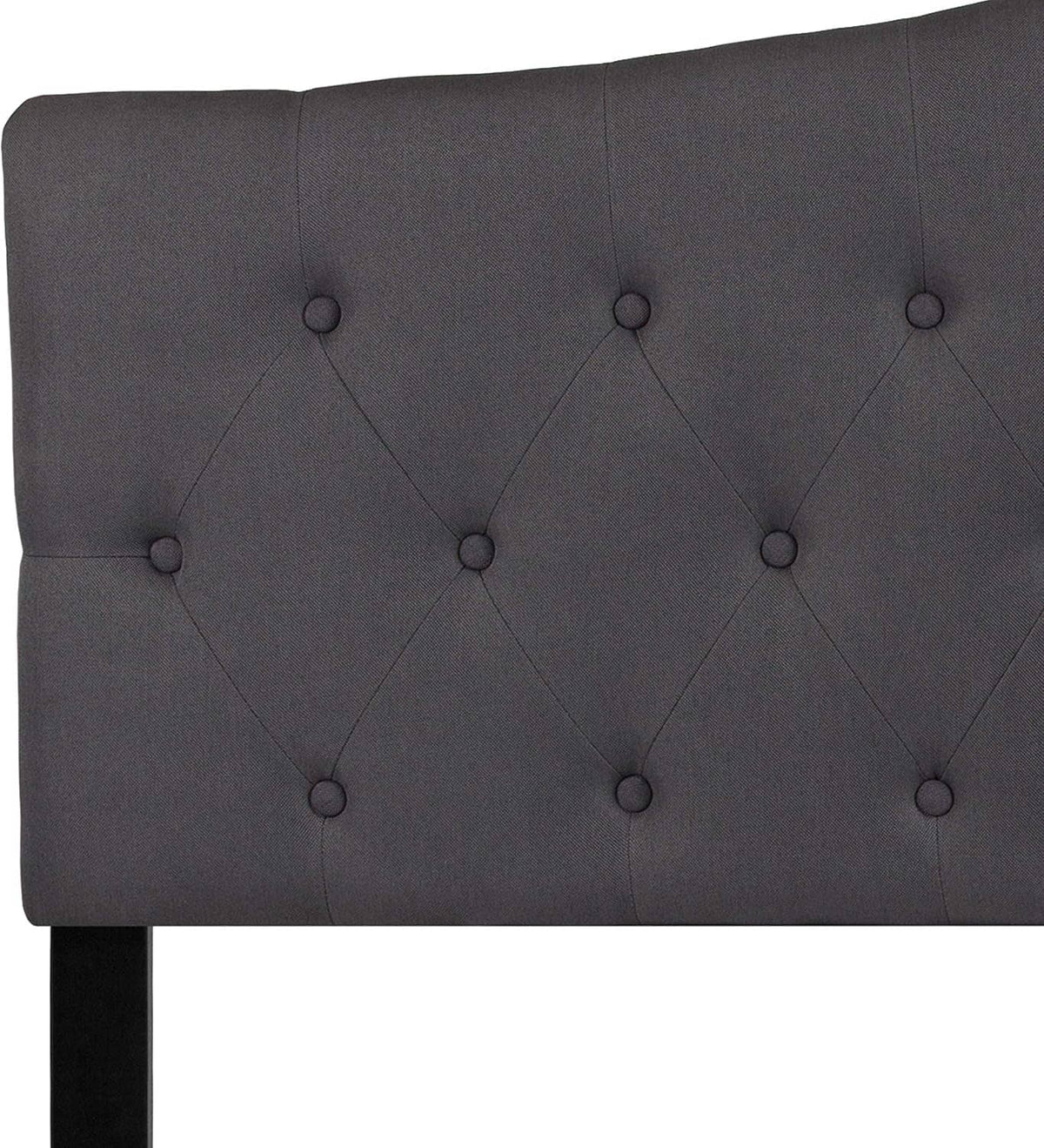 Dark gray tufted fabric headboard panel with buttoned diamond pattern