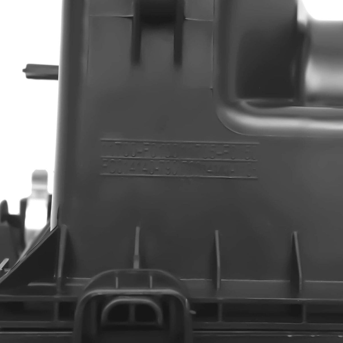 Air cleaner box intake housing, dark plastic, close-up of intake port and ribs