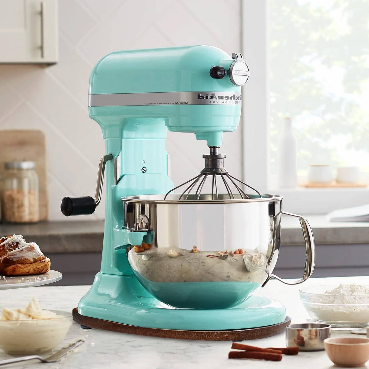 Walnut oval mixer slider mat under a light teal stand mixer