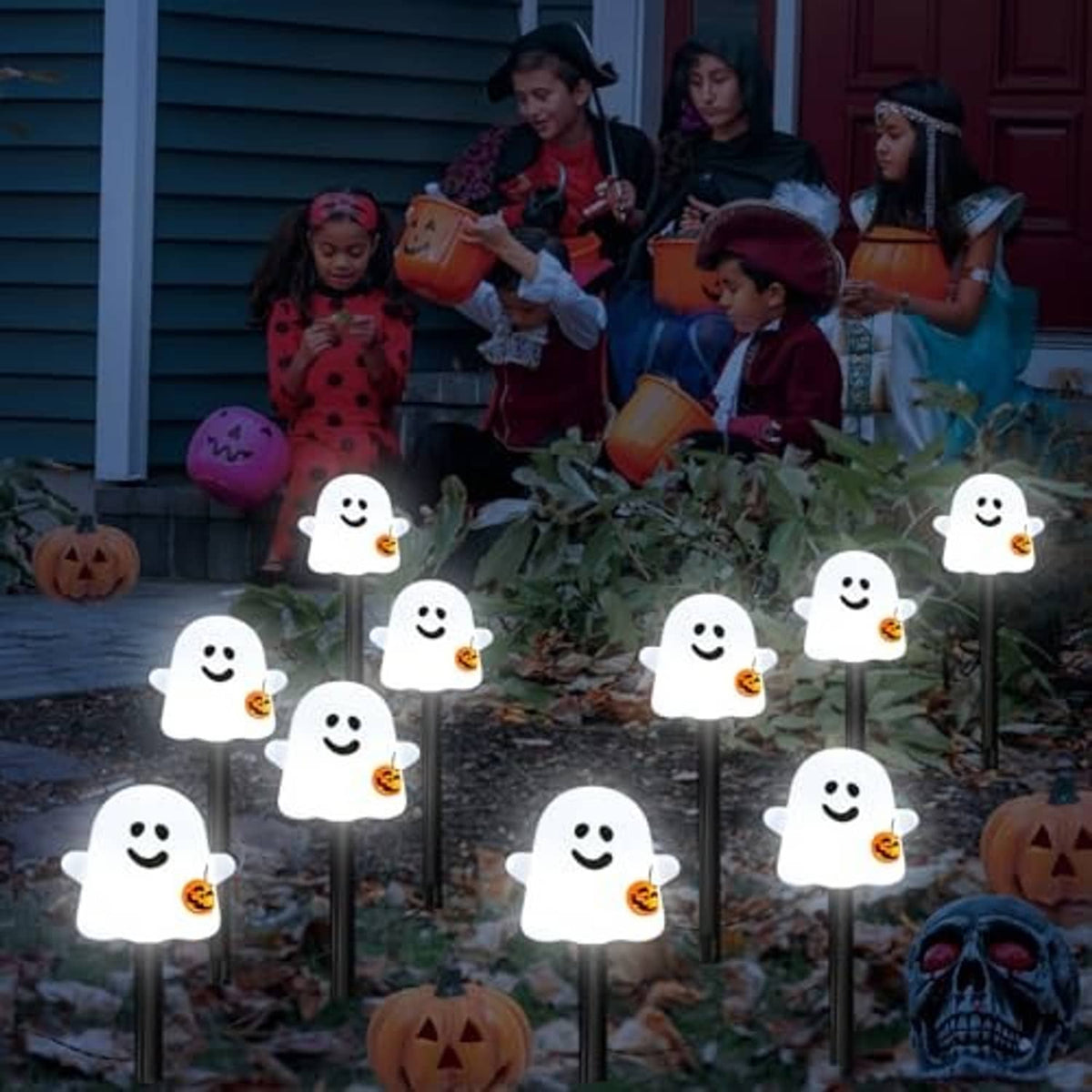 White glowing ghost solar pathway lights on stakes with jack-o'-lantern buckets