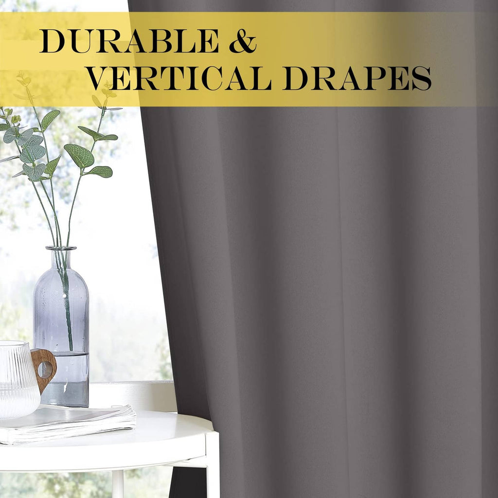 Grey blackout curtain panel with vertical drape over an open window